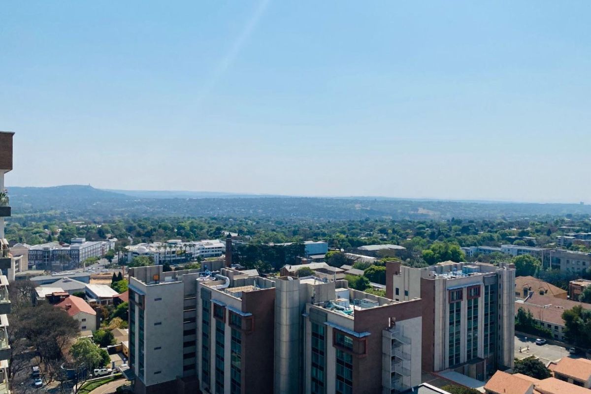 Elevated aerial view showcasing the surrounding urban landscape and neighborhood skyline from a high vantage point.