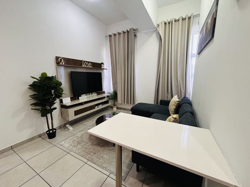 A well-maintained living room featuring tiled flooring and a built-in media console, offering a functional and comfortable space.