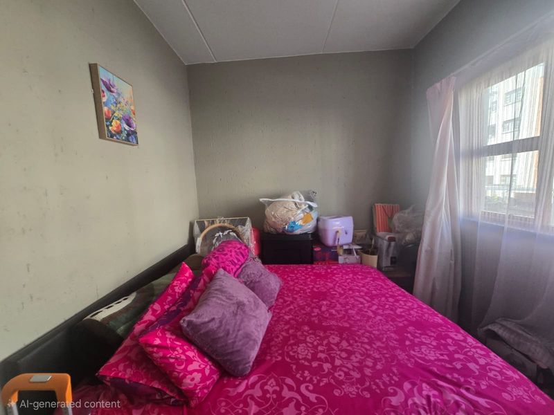 A bedroom featuring a window with curtains and neutral wall finishes, offering a functional space for rest.