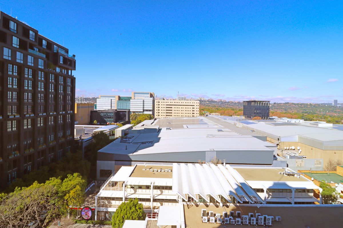 An elevated aerial view showcasing the surrounding urban landscape and commercial building rooftops.