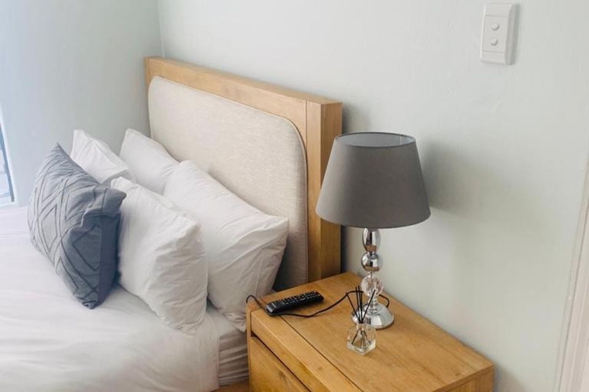A well-maintained bedroom featuring neutral wall finishes and carpet flooring.