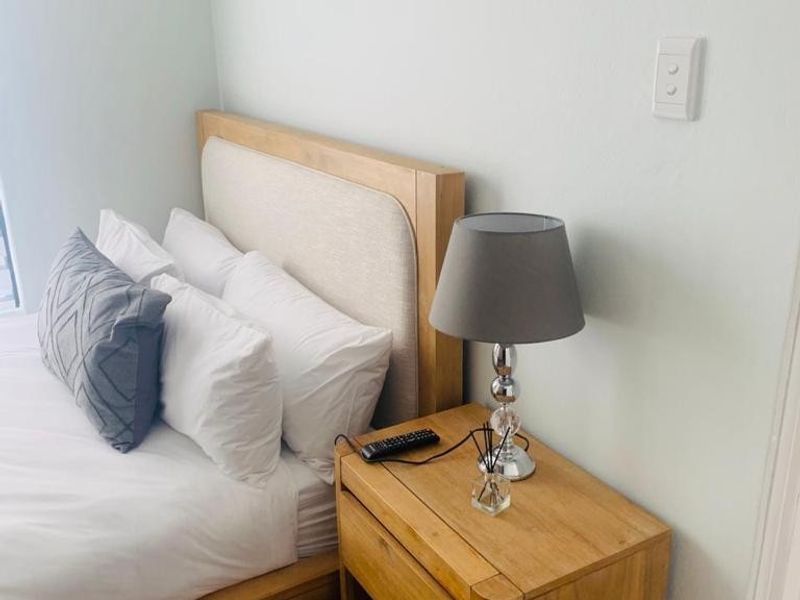 A well-maintained bedroom featuring neutral wall finishes and carpet flooring.
