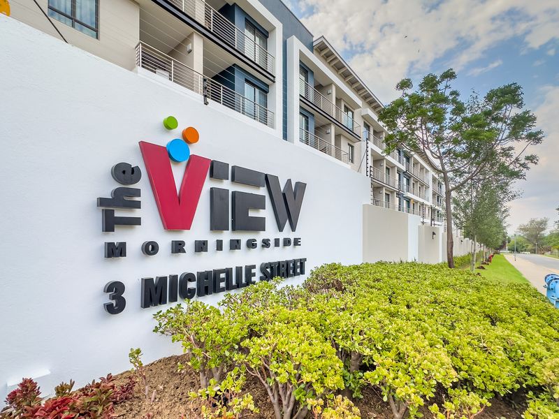 Exterior view of The View Morningside apartment complex, featuring modern building architecture, signage, and landscaped boundary wall.
