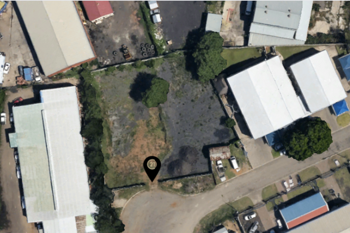 Aerial view of a vacant commercial land plot situated within an established industrial or commercial precinct.