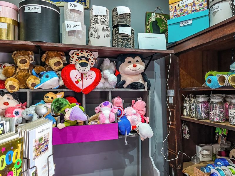 A retail display area featuring built-in wooden shelving units used for organizing merchandise and inventory.