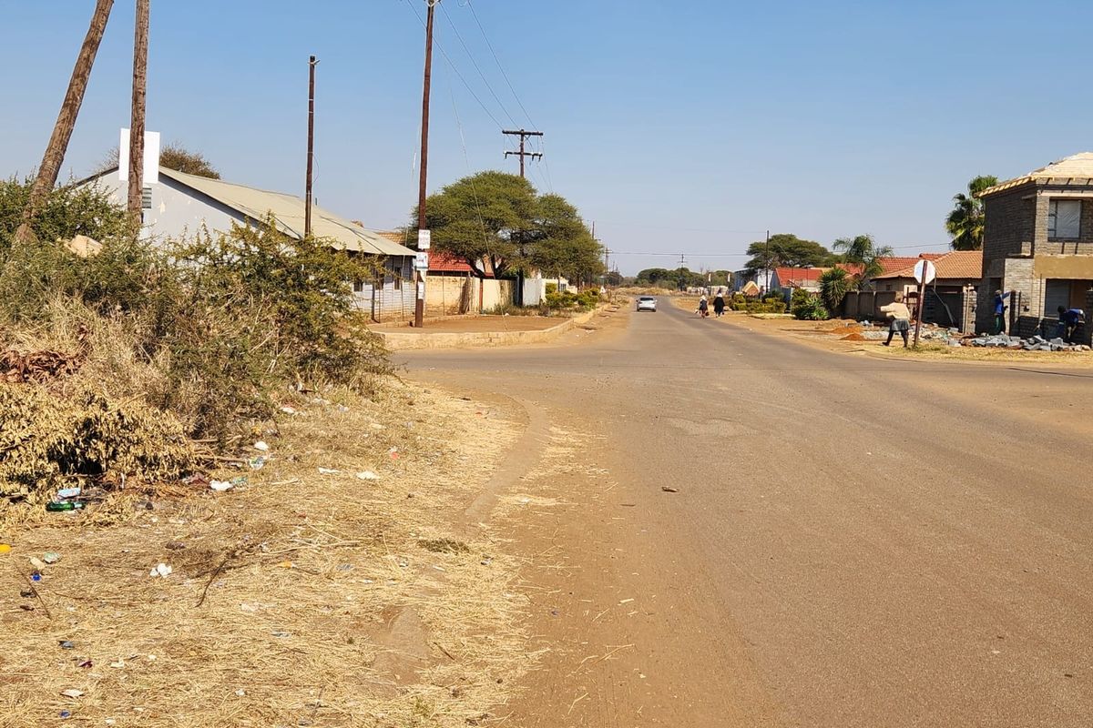 A street view showing the local road infrastructure, utility poles, and surrounding residential area in a commercial vacant land context.