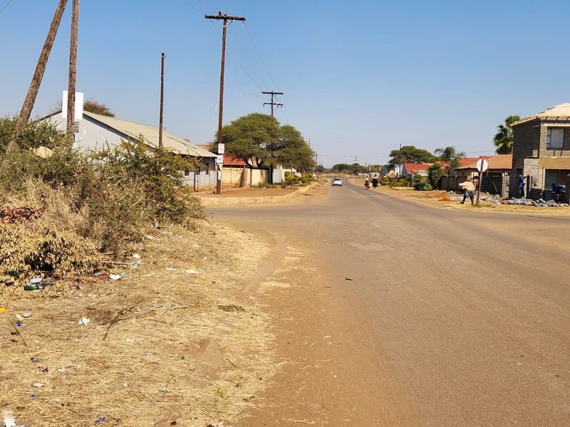A street view showing the local road infrastructure, utility poles, and surrounding residential area in a commercial vacant land context.