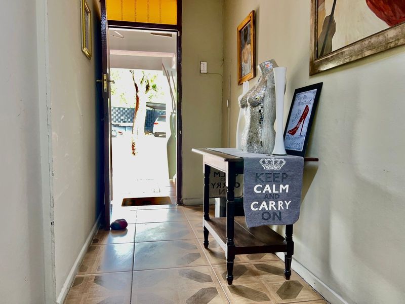 Entrance hallway featuring tiled flooring and direct access to the exterior, providing a functional transition space for the apartment.