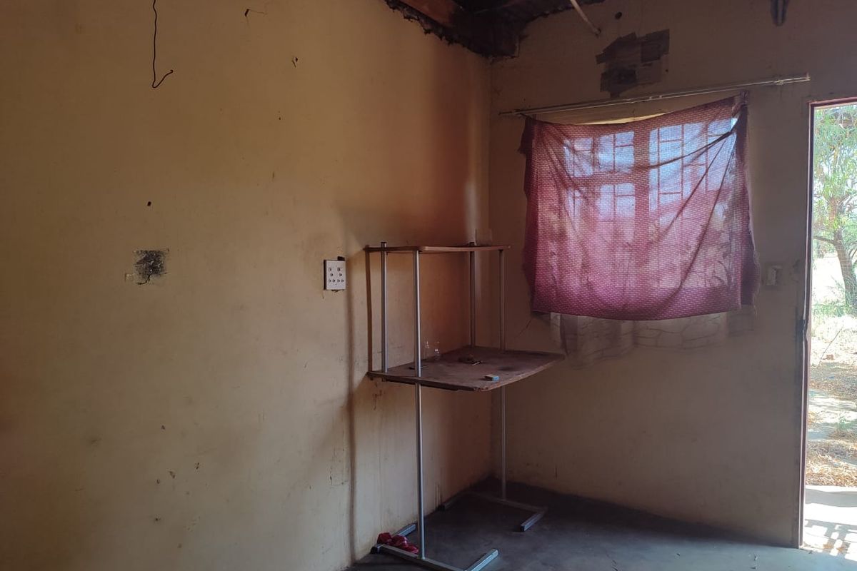 A basic interior room featuring concrete flooring, exposed wall wiring, and a single window with natural light access.