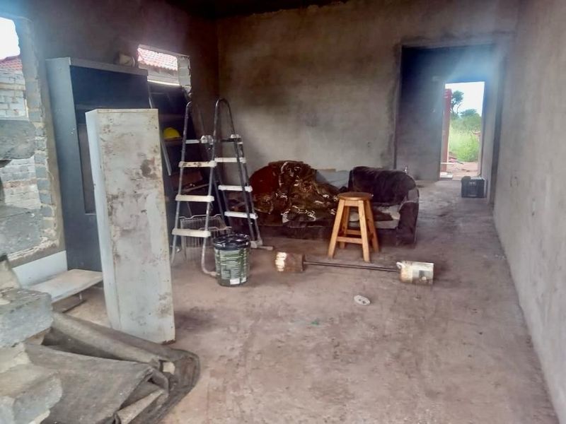 An unfinished interior space featuring raw concrete walls and flooring, offering a blank canvas for complete renovation and custom interior design.