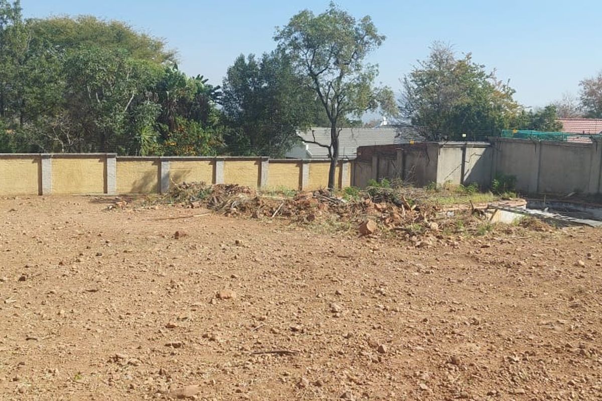 Vacant residential land featuring a perimeter wall with electric fencing and an existing swimming pool shell requiring restoration.