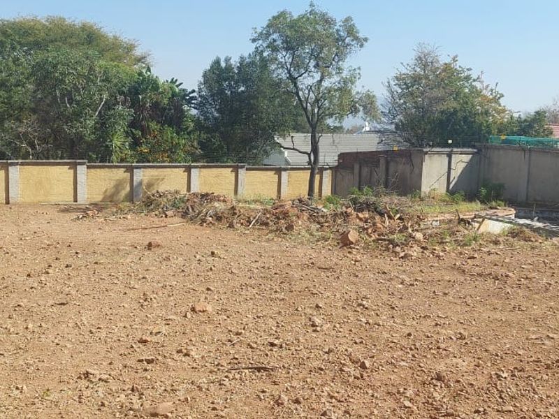 Vacant residential land featuring a perimeter wall with electric fencing and an existing swimming pool shell requiring restoration.