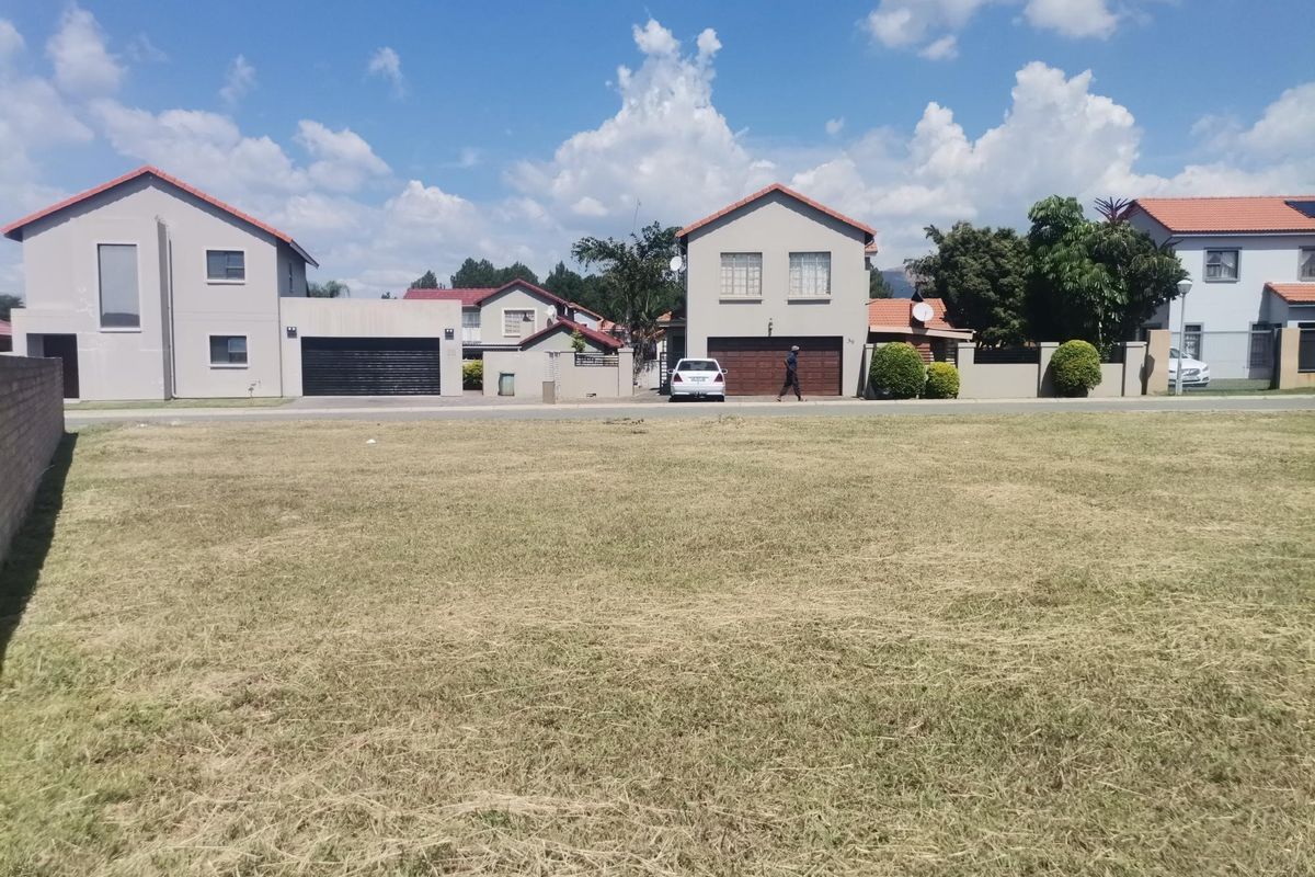 A clear, level vacant residential plot of land situated in a developed suburban neighborhood.
