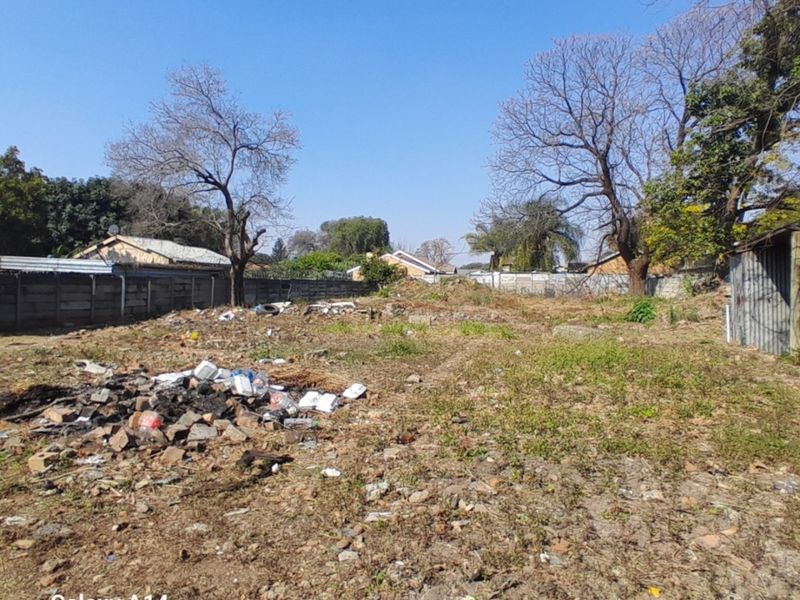 A vacant residential plot featuring perimeter walling and existing debris, offering a blank canvas for future development.
