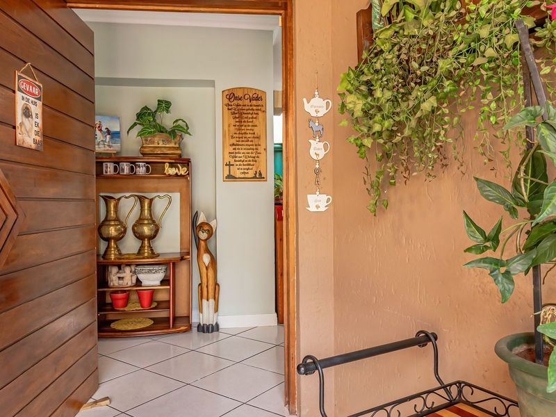 Entrance area featuring a solid timber door and ceramic tiled flooring, providing a welcoming transition into the home.