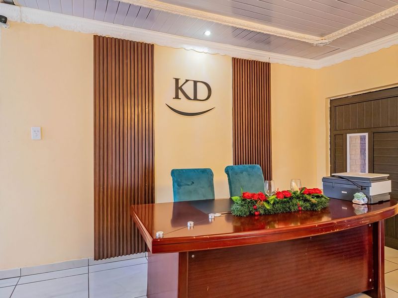 A professional office space featuring timber wall paneling, tiled flooring, and a split-system air conditioner.