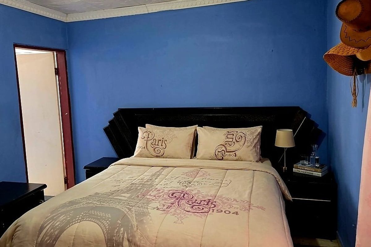A bedroom featuring blue painted walls and decorative crown molding.