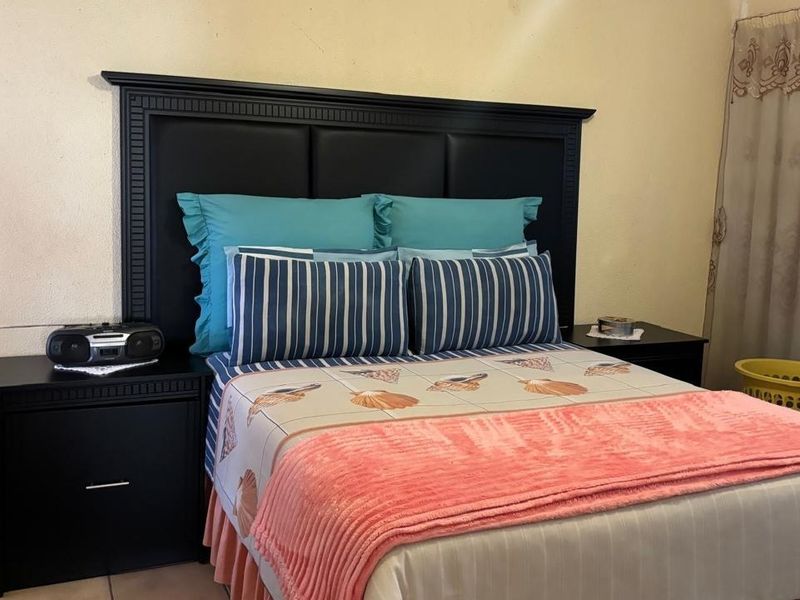 A standard bedroom featuring neutral wall finishes and basic electrical infrastructure.
