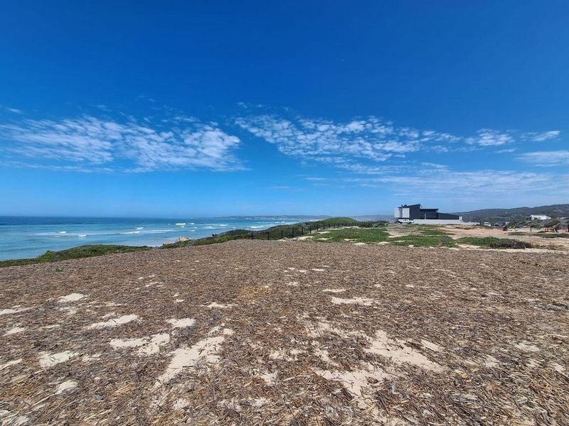 A scenic view of the coastal landscape and ocean, showcasing the prime location of this vacant residential land.