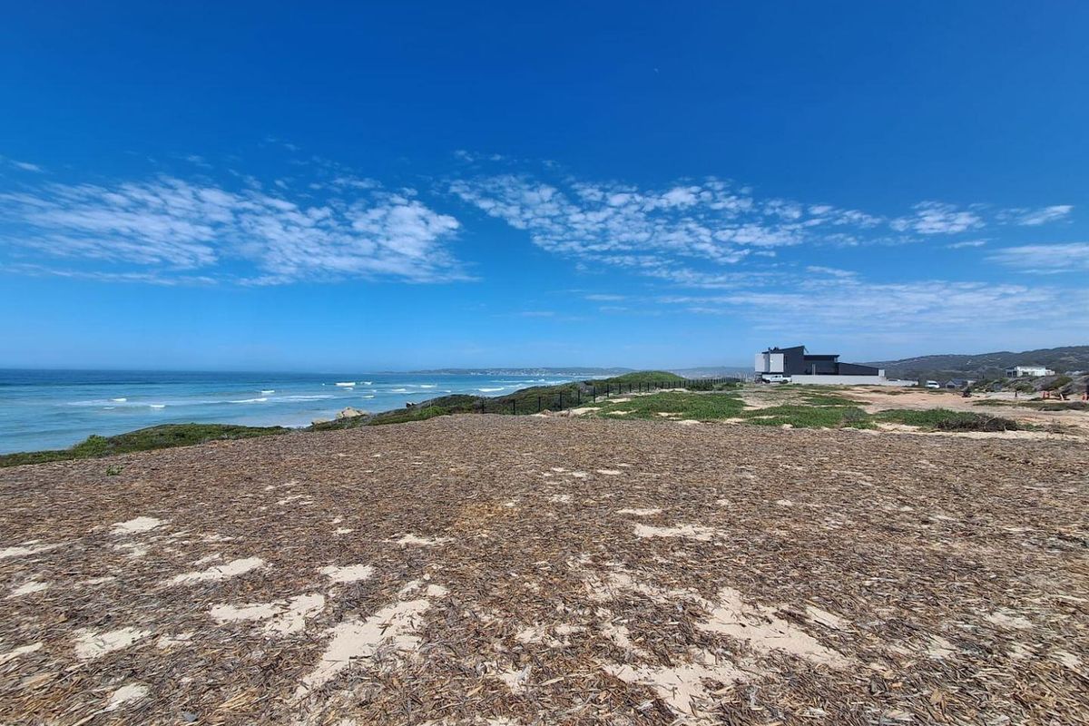 A scenic view of the coastal landscape and ocean, showcasing the prime location of this vacant residential land.