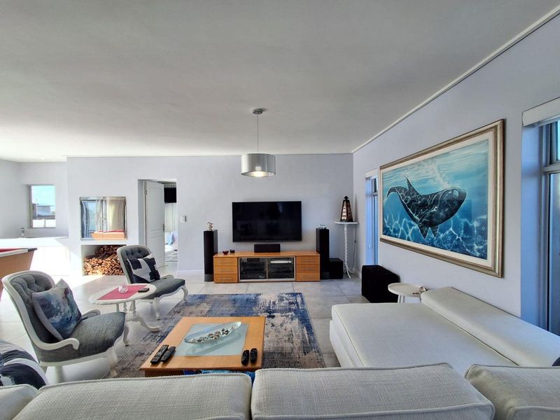 Spacious living room featuring tiled flooring, a built-in fireplace, and neutral wall finishes, creating a comfortable and functional family entertainment area.