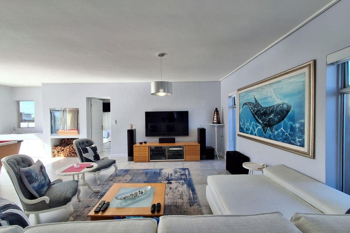 Spacious living room featuring tiled flooring, a built-in fireplace, and neutral wall finishes, creating a comfortable and functional family entertainment area.