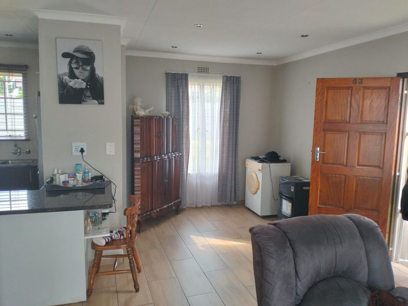 Open plan living area featuring tiled flooring, recessed lighting, and a kitchen breakfast nook with granite countertops.