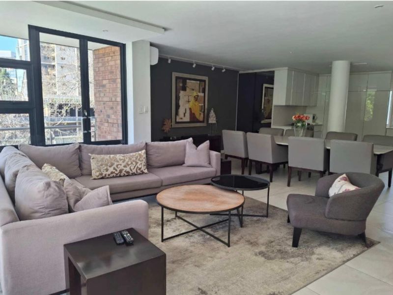Spacious open-plan living and dining area featuring modern finishes, large windows, and a seamless flow into the integrated kitchen space.
