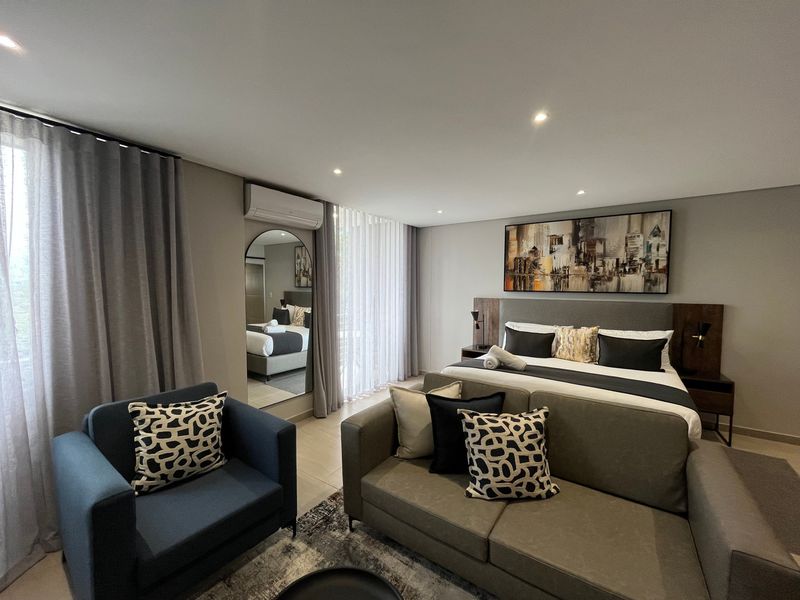 A modern, well-maintained bedroom featuring tiled flooring, recessed lighting, and a split-system air conditioning unit, offering a comfortable and contemporary living space.
