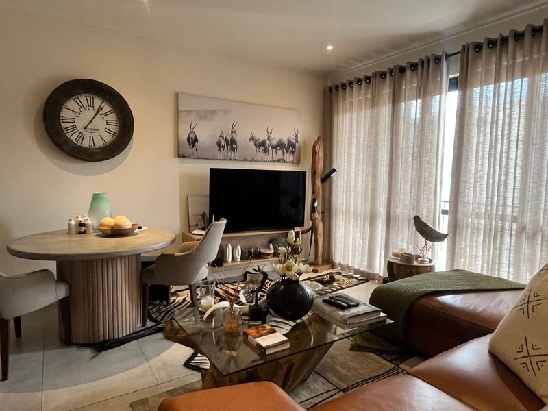 Open plan living and dining area featuring tiled flooring, recessed lighting, and large sliding glass doors providing access to the balcony.