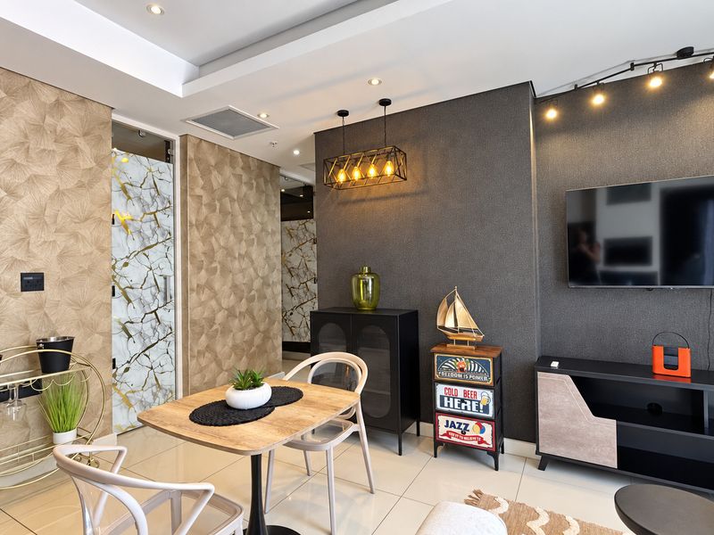 A modern living room featuring textured feature walls, recessed ceiling lighting, track lighting, and polished tiled flooring.