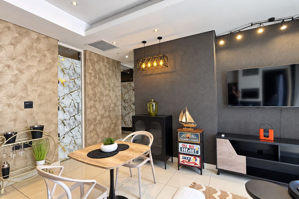 A modern living room featuring textured feature walls, recessed ceiling lighting, track lighting, and polished tiled flooring.