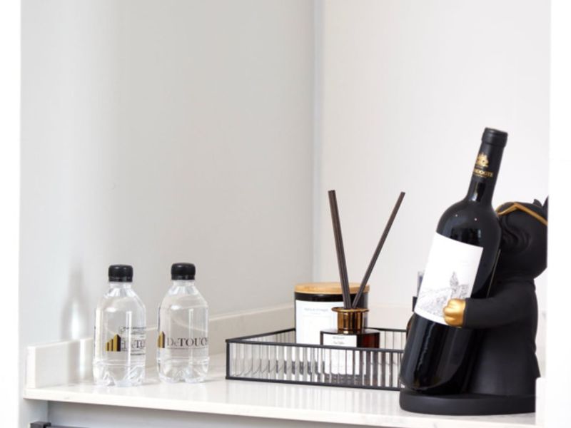 A close-up view of a modern kitchen countertop featuring sleek dark cabinetry and a clean stone surface.
