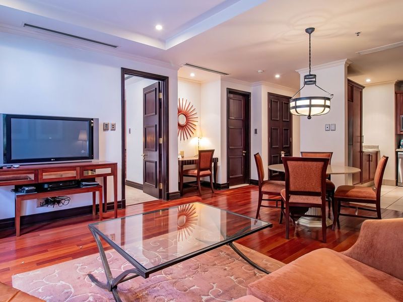 Spacious open-plan living and dining area featuring rich hardwood flooring, recessed lighting, and a well-appointed kitchen with integrated appliances.