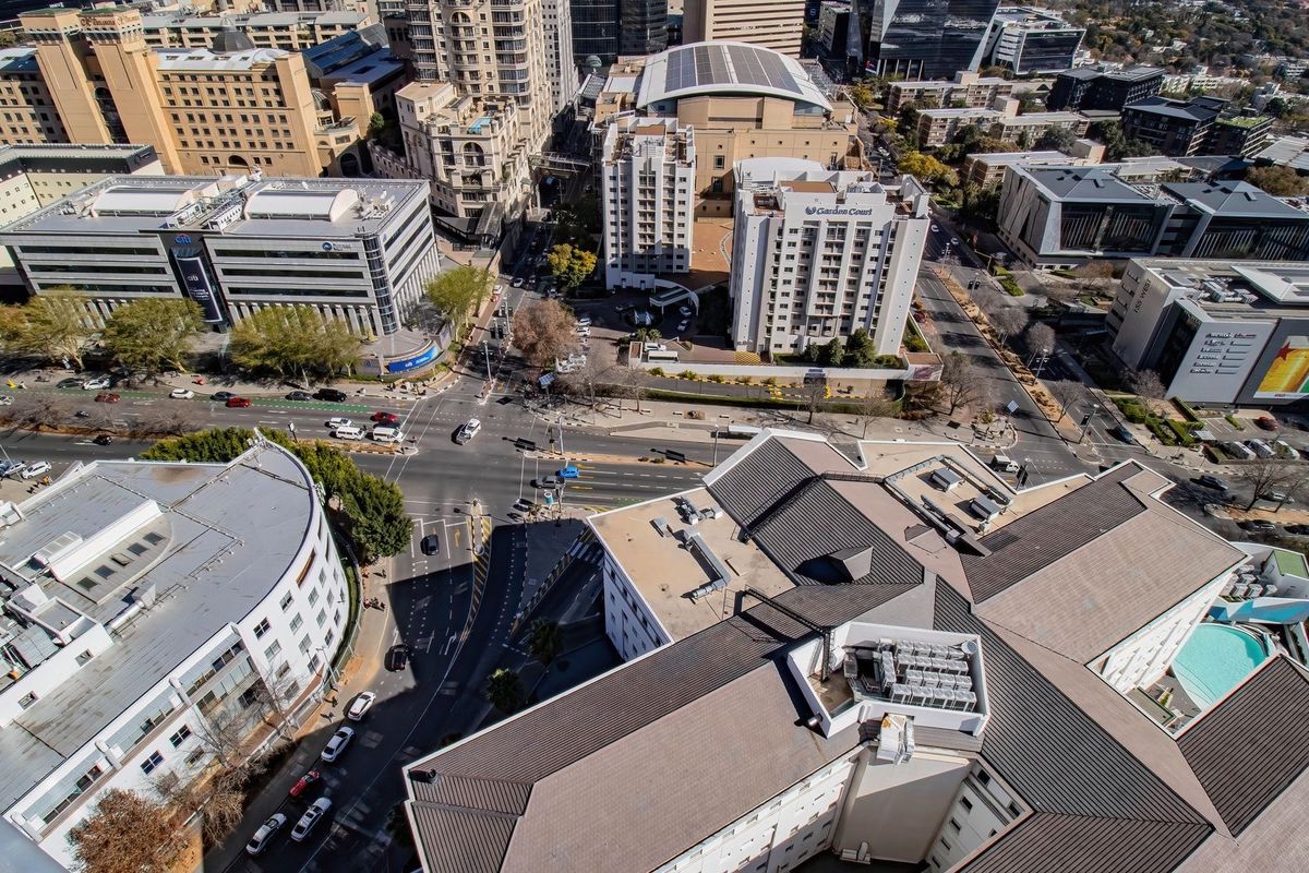 An aerial view of the surrounding urban landscape and city infrastructure, showcasing the property's location within the metropolitan area.
