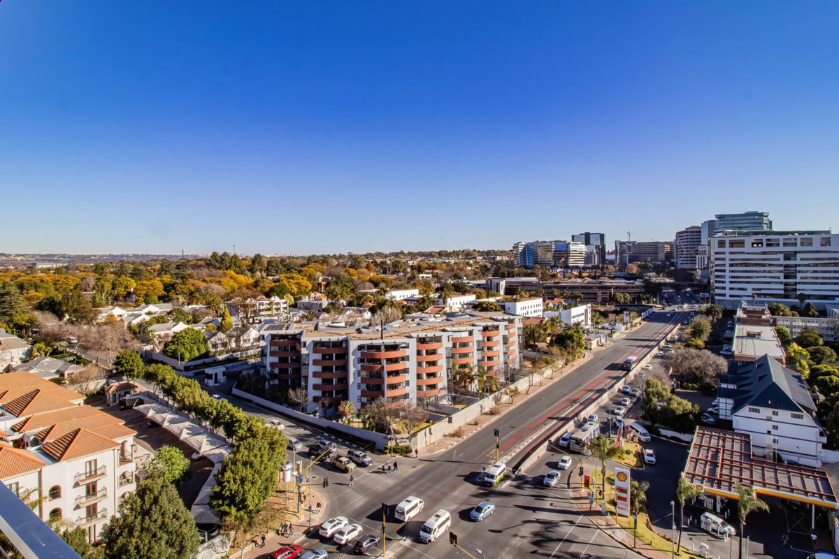 An elevated aerial view showcasing the surrounding urban landscape, nearby residential apartment complexes, and major road infrastructure.
