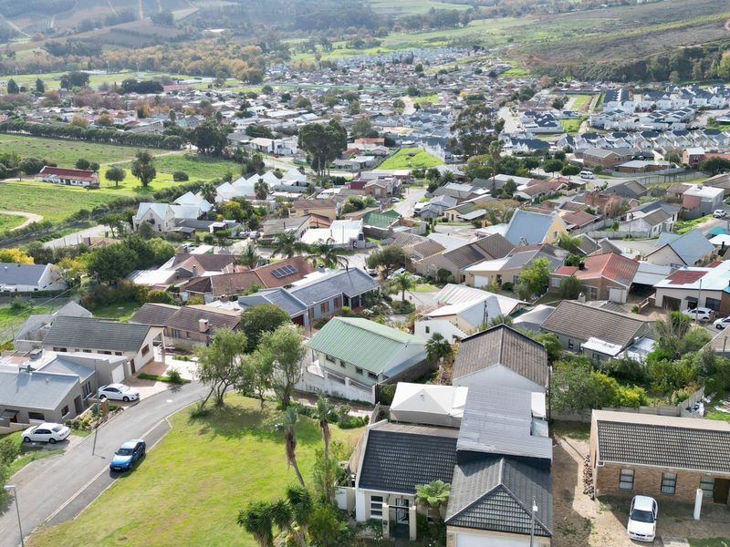 An elevated aerial view showcasing the surrounding residential neighbourhood and local landscape.