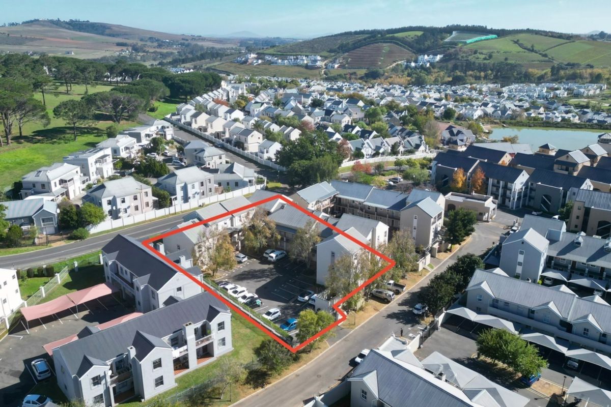 Aerial view of the apartment complex highlighting the designated parking area and surrounding residential estate infrastructure.