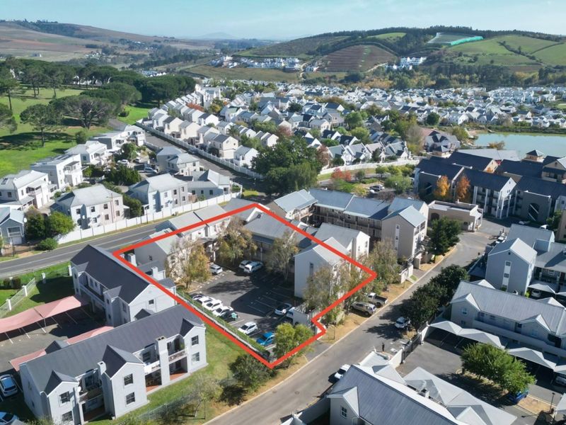 Aerial view of the apartment complex highlighting the designated parking area and surrounding residential estate infrastructure.