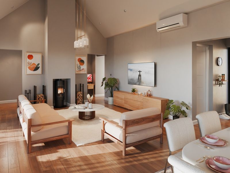 Spacious open-plan living area featuring vaulted ceilings, hardwood flooring, a modern freestanding fireplace, and integrated split-system air conditioning.