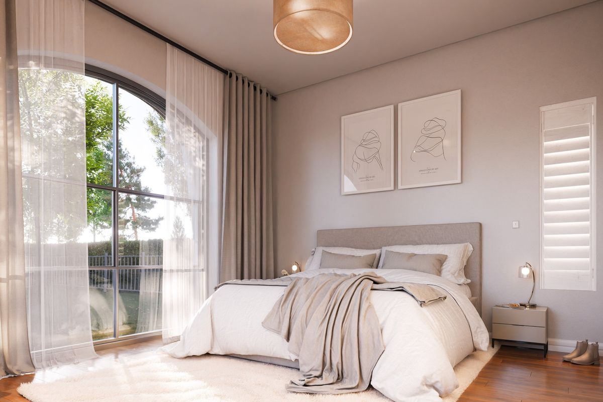 A bright and modern bedroom featuring an elegant arched window, hardwood flooring, and built-in storage, offering a serene and well-maintained living space.