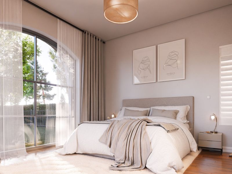 A bright and modern bedroom featuring an elegant arched window, hardwood flooring, and built-in storage, offering a serene and well-maintained living space.