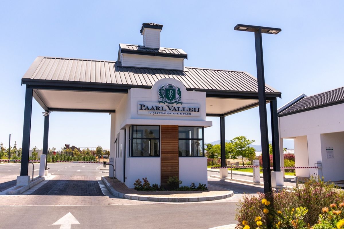 The main entrance gatehouse of Pearl Valley Lifestyle Estate, featuring a modern architectural design, secure boom gates, and well-maintained landscaped surroundings.