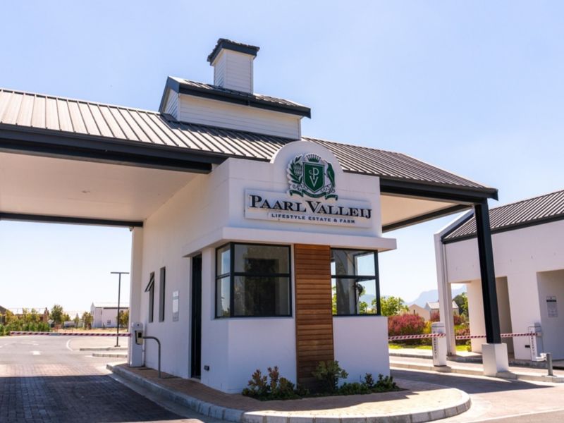 The main entrance gatehouse of Paarl Valleij Lifestyle Estate and Farm, featuring modern architecture, secure boom gates, and paved access.
