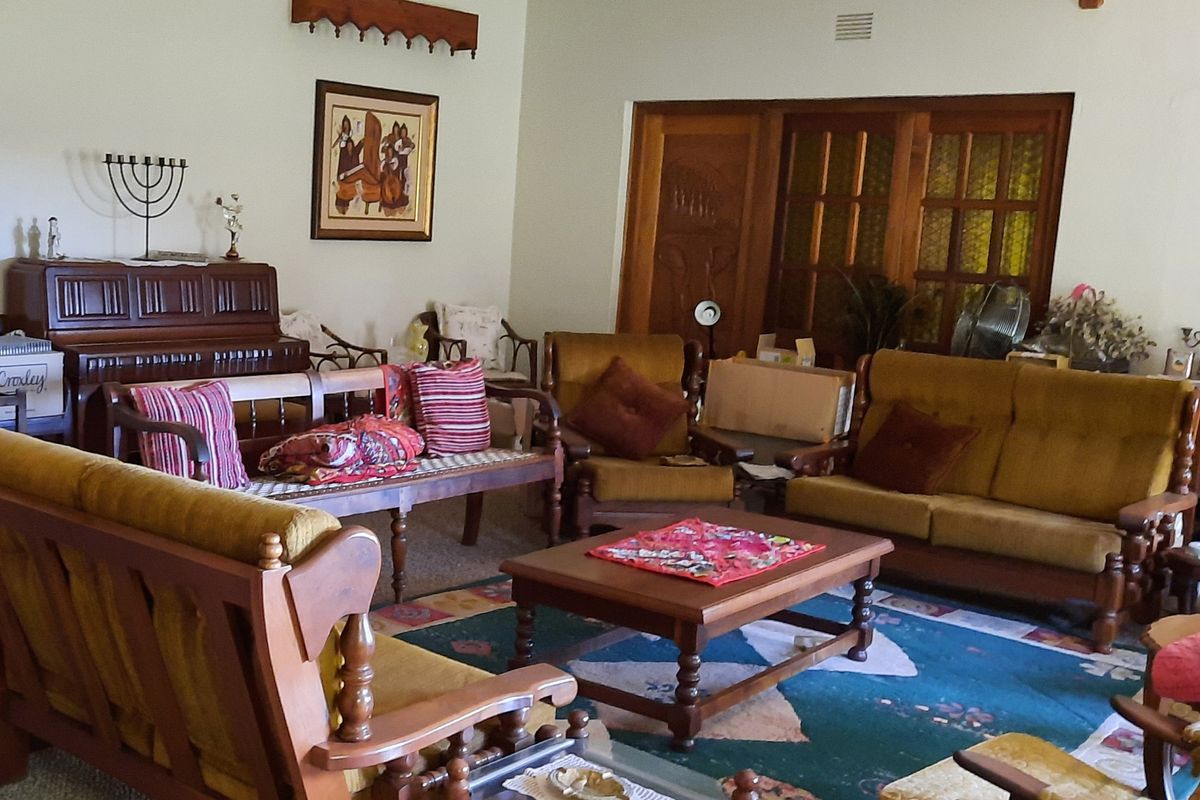 A spacious living room featuring wooden door frames and classic architectural details, providing a comfortable and traditional living environment.