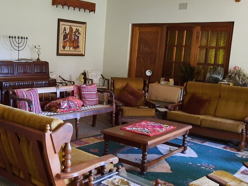 A spacious living room featuring wooden door frames and classic architectural details, providing a comfortable and traditional living environment.