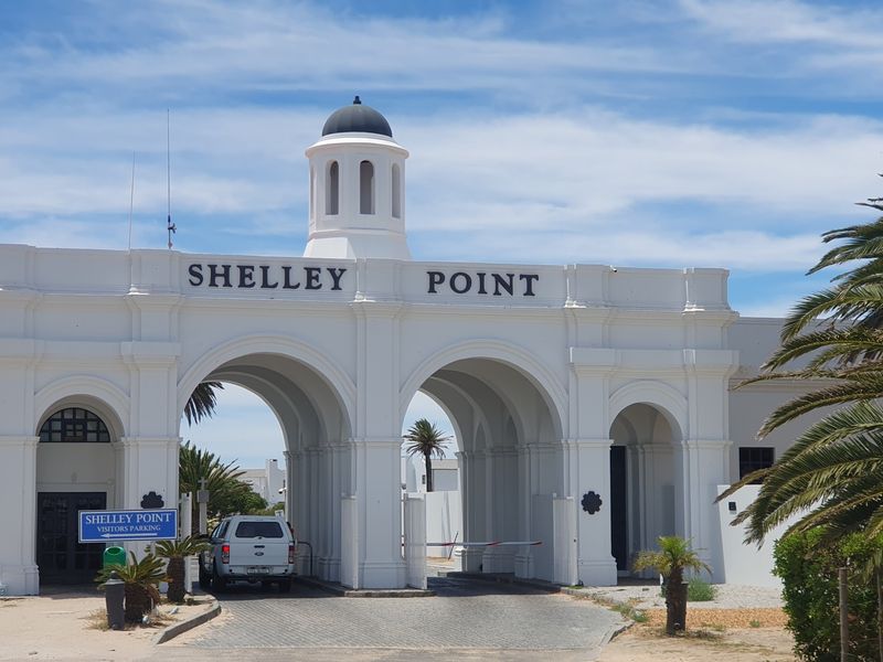 The grand entrance gatehouse of Shelley Point estate, featuring classic architectural archways and a central cupola.