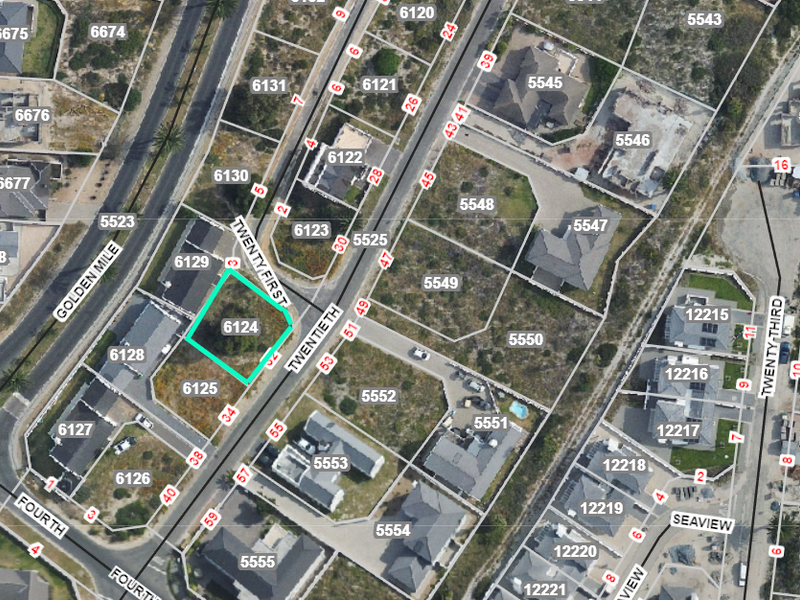 An aerial view of a residential vacant land plot, identified as erf 6124, situated within a developed coastal estate.