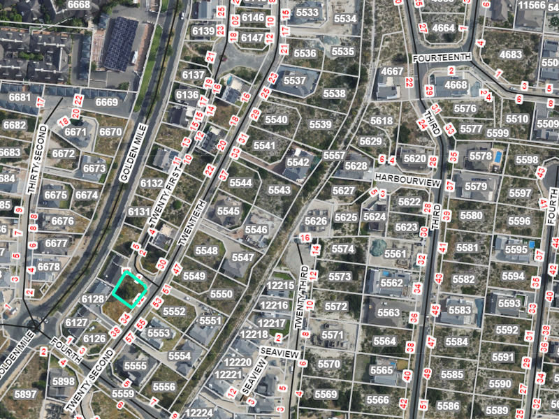 An aerial view of the residential estate showing the specific vacant land plot highlighted within the surrounding street and property layout.