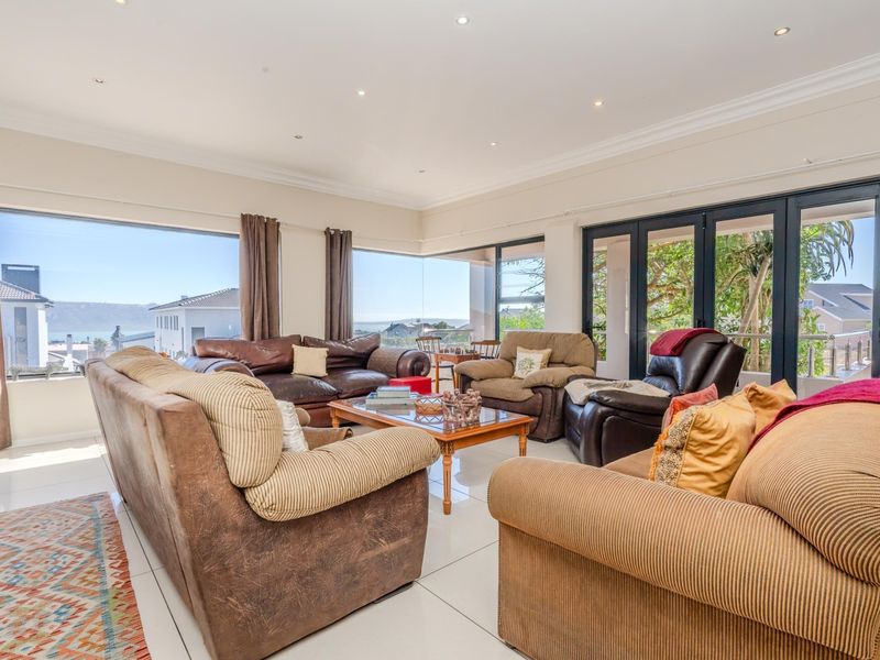 Spacious living room featuring large picture windows and sliding glass doors that provide abundant natural light and scenic views.